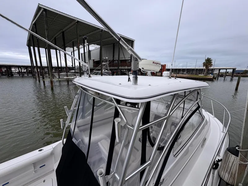 Slide: The Image of 2006 Pro-Line 32 Express boat docked at marina under cloudy sky. - 7