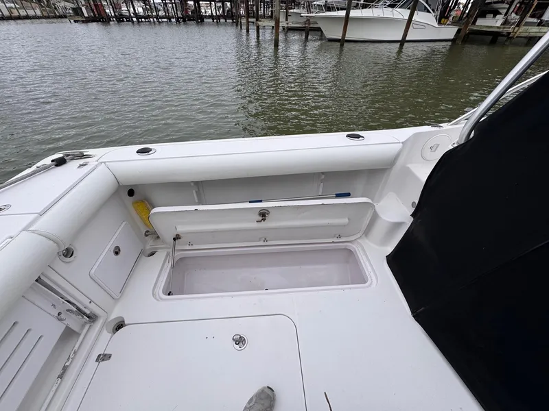 Slide: The Image of 2006 Pro-Line 32 Express boat deck with open storage compartment by the water. - 9