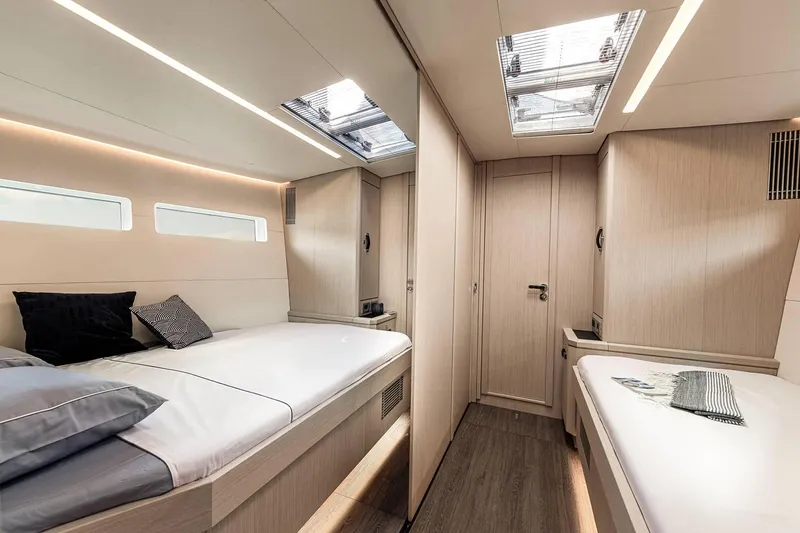 Slide: The Image of Modern cabin interior of 2024 Jeanneau 60 yacht with twin beds and skylights. - 25
