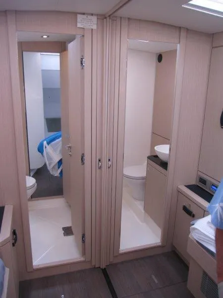 Slide: The Image of 2024 Jeanneau 60 yacht interior with modern bathroom and storage space. - 27
