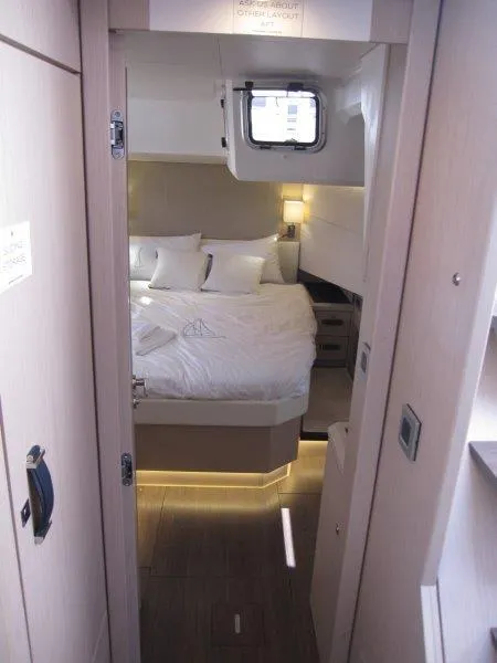 Slide: The Image of 2024 Jeanneau 60 yacht interior cabin with bed and modern lighting. - 38