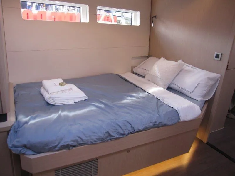 Slide: The Image of Luxurious bedroom interior of 2024 Jeanneau 60 yacht with neatly made bed. - 29