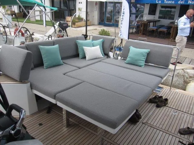 Slide: The Image of Jeanneau 55 2024 model yacht with spacious outdoor seating area and cushions. - 14