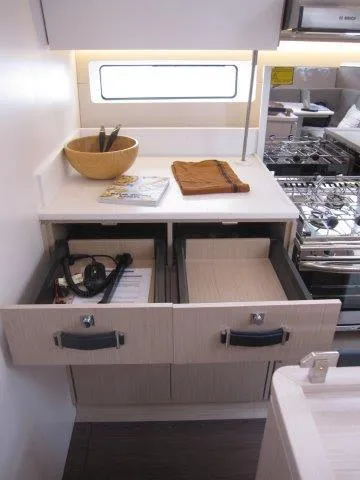 Slide: The Image of 2024 Jeanneau 55 yacht kitchen with open drawers and modern appliances. - 35