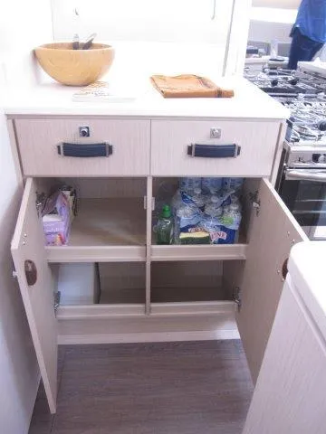 Slide: The Image of Modern kitchen storage in 2024 Jeanneau 55 yacht with open cabinets and drawers. - 36