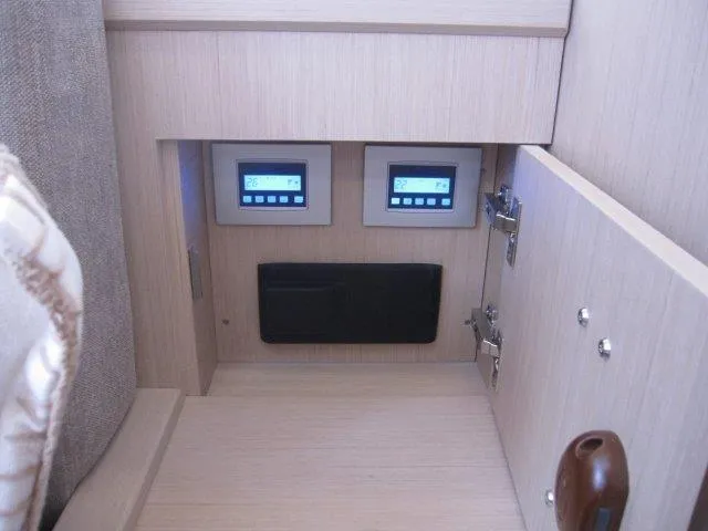 Slide: The Image of Control panel inside Jeanneau 55 yacht, 2024 model, featuring digital displays and storage compartment. - 42