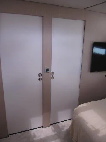 Slide: The Image of Modern interior of 2024 Jeanneau 55 yacht with dual doors and wall-mounted TV. - 44