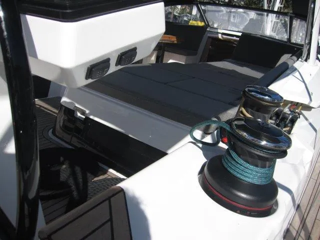 Slide: The Image of 2025 Jeanneau Yacht 65 deck with winches and seating area. - 18