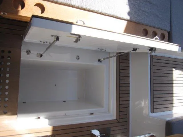 Slide: The Image of Open storage compartment on the 2025 Jeanneau Yacht 65 deck. - 44