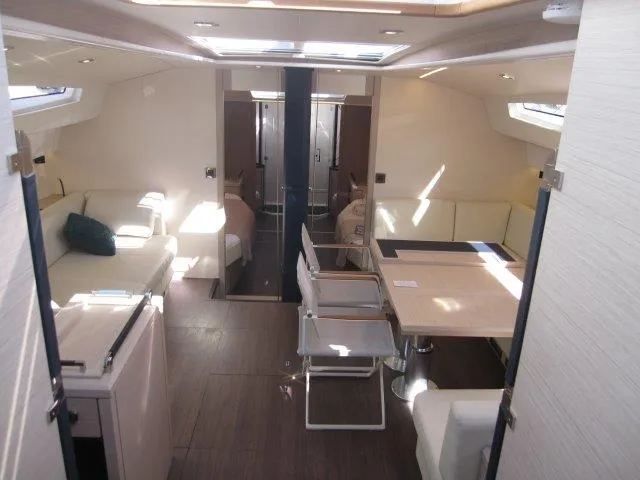 Slide: The Image of 2025 Jeanneau Yacht 65 interior, modern design with spacious seating and dining area. - 46