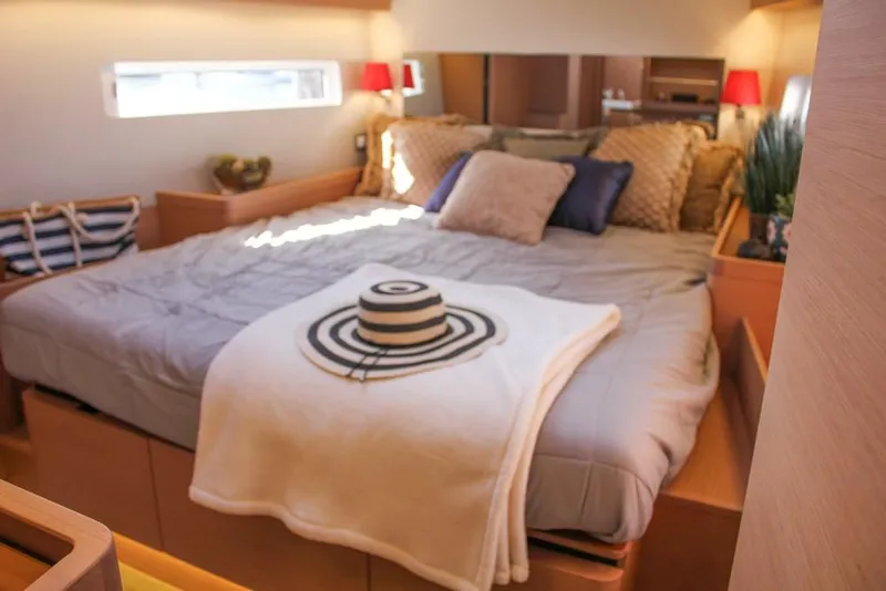Slide: The Image of Luxurious bedroom interior of 2024 Jeanneau Sun Odyssey 490 yacht with cozy bedding. - 1