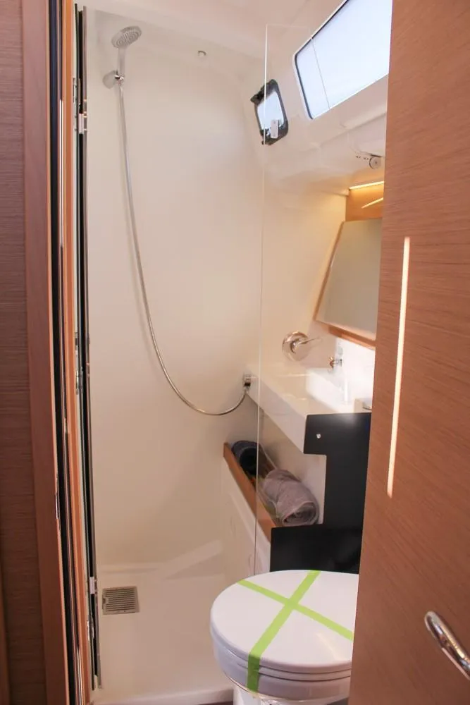 Slide: The Image of 2024 Jeanneau Sun Odyssey 490 bathroom with shower, sink, and toilet. - 17