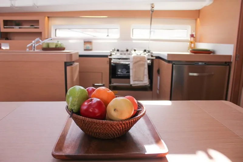 Slide: The Image of Modern kitchen interior of Jeanneau Sun Odyssey 490 yacht, 2024 model, with fruit bowl centerpiece. - 19