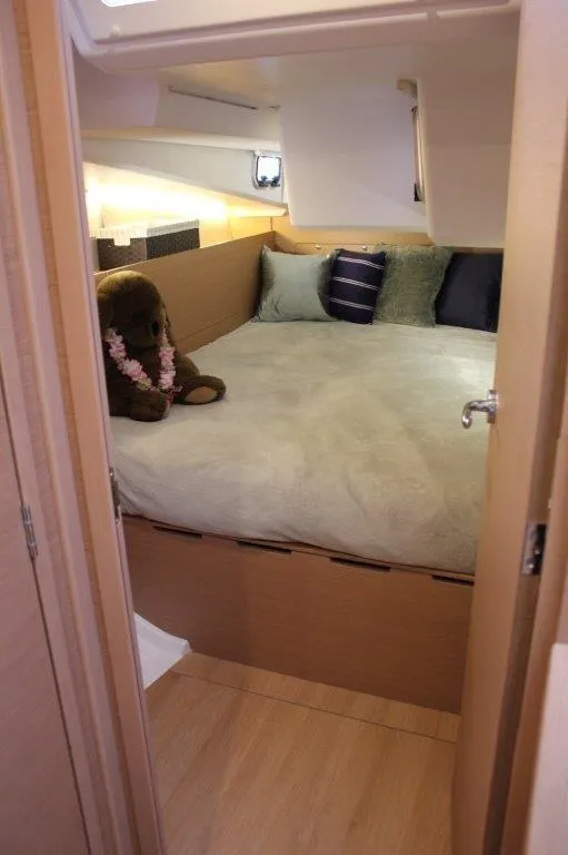Slide: The Image of Cozy bedroom in 2024 Jeanneau Sun Odyssey 490 yacht with plush bedding and decorative pillows. - 30