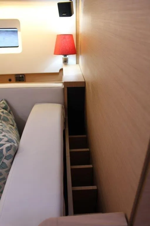 Slide: The Image of Interior of 2024 Jeanneau Sun Odyssey 490 with red lamp and storage shelves. - 42
