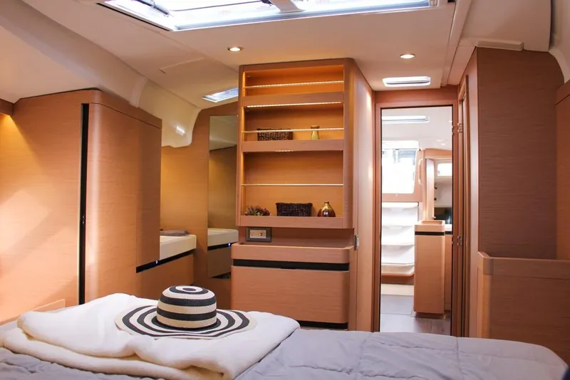 Slide: The Image of Interior of 2024 Jeanneau Sun Odyssey 490 yacht, featuring modern wood finishes and ample natural light. - 6