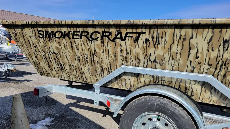 Slide: The Image of 2025 Smoker Craft Sportsman 1866 camo boat on trailer, side view. - 10