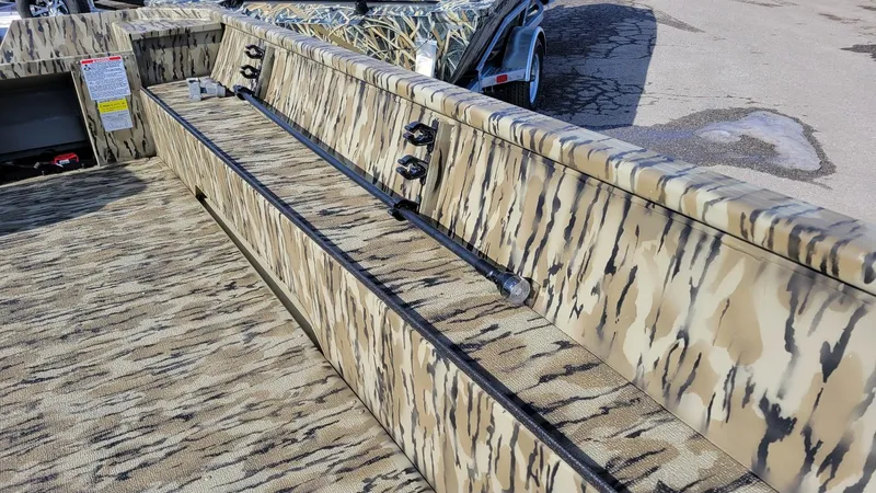 Slide: The Image of 2025 Smoker Craft Sportsman 1866 camo interior, featuring durable seating and storage. - 16