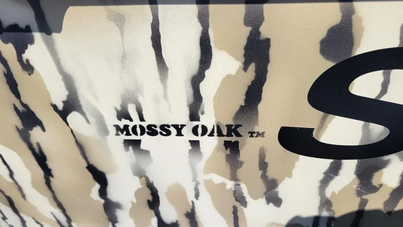 Slide: The Image of Camo pattern with "Mossy Oak" logo on Smoker Craft Sportsman 1866, 2025 model. - 3