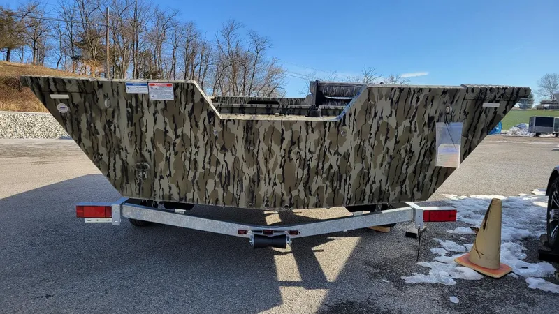 Slide: The Image of 2025 Smoker Craft Sportsman 1866 camo boat on trailer, rear view. - 7