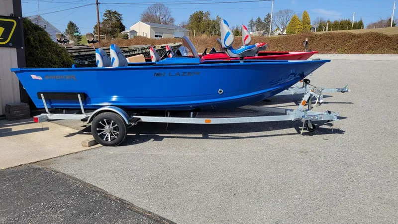 The Image of 2025 Smoker Craft Lazer 161 side console boat on trailer, blue exterior, in stock. - 1