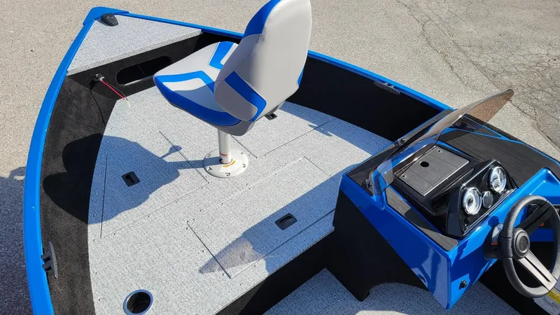 Slide: The Image of 2025 Smoker Craft Lazer 161 side console boat with blue accents and seating. - 11