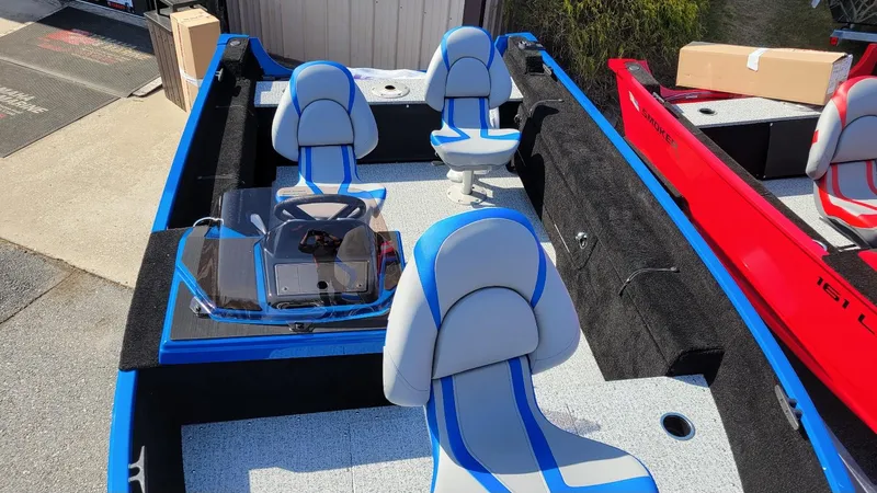 Slide: The Image of 2025 Smoker Craft Lazer 161 side console boat with blue and gray seating, in stock. - 12
