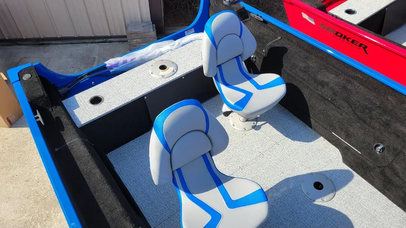 Slide: The Image of 2025 Smoker Craft Lazer 161 side console boat interior with blue and gray seating. - 15