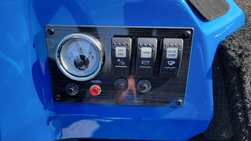 Slide: The Image of 2025 Smoker Craft Lazer 161 side console dashboard with fuel gauge and control switches. - 5