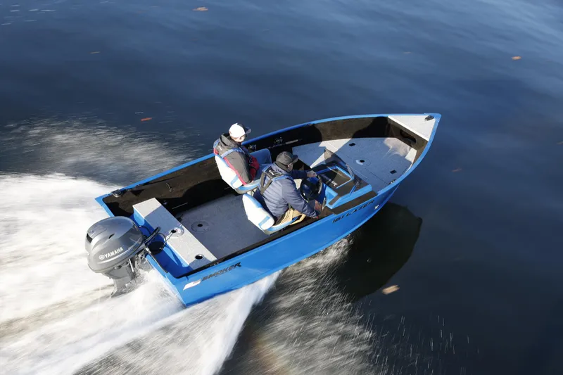 Slide: The Image of 2025 Smoker Craft Lazer 161 side console boat cruising on water. - 9