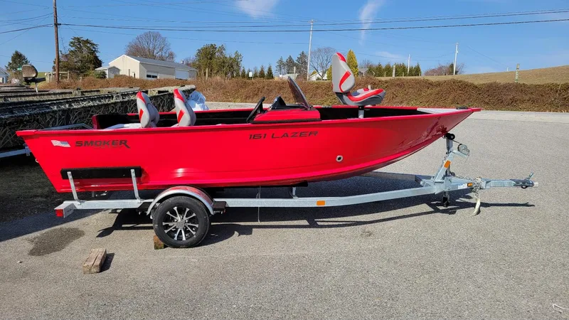 The Image of 2025 Smoker Craft Lazer 161 side console boat in vibrant red on trailer. - 1