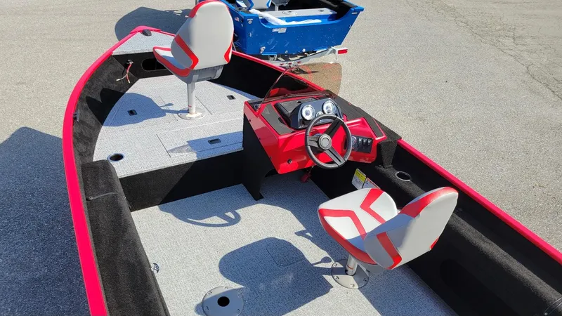 Slide: The Image of 2025 Smoker Craft Lazer 161 side console boat with red and gray seating. - 4