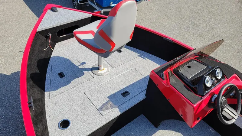 Slide: The Image of 2025 Smoker Craft Lazer 161 side console boat with red accents and modern seating. - 5
