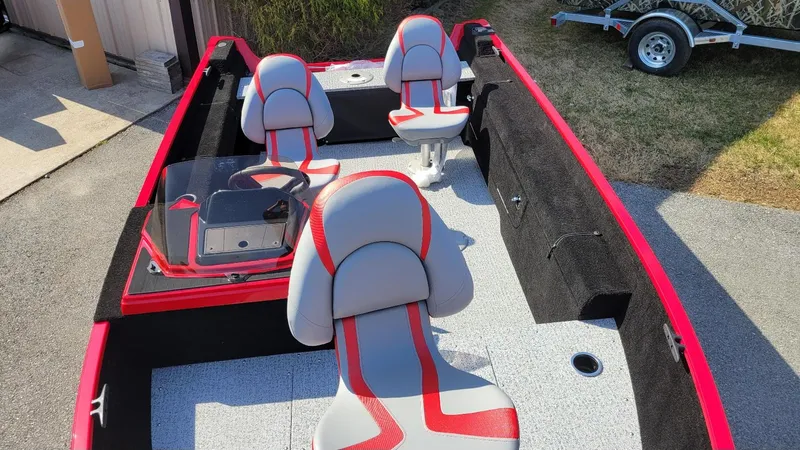 Slide: The Image of 2025 Smoker Craft Lazer 161 side console boat with red and gray seating, in stock. - 6