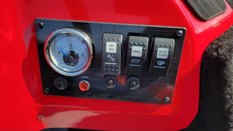 Slide: The Image of 2025 Smoker Craft Lazer 161 side console dashboard with fuel gauge and control switches. - 7