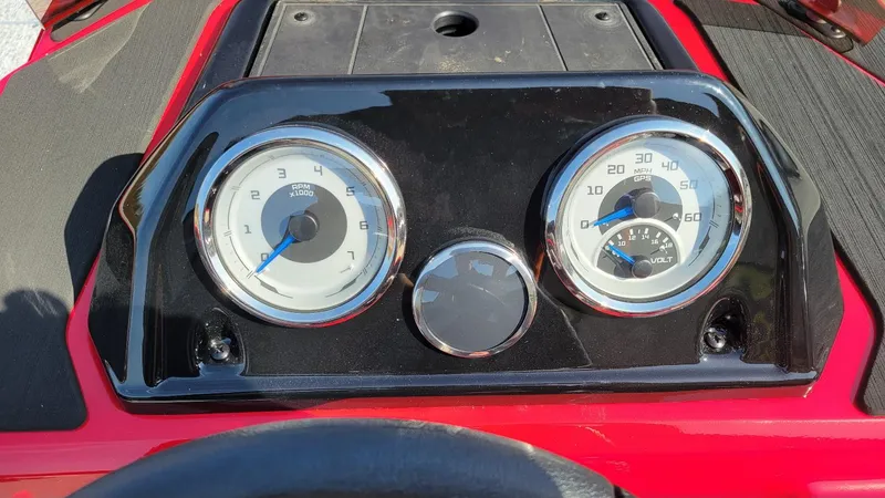 Slide: The Image of 2025 Smoker Craft Lazer 161 side console dashboard with RPM and speed gauges. - 8