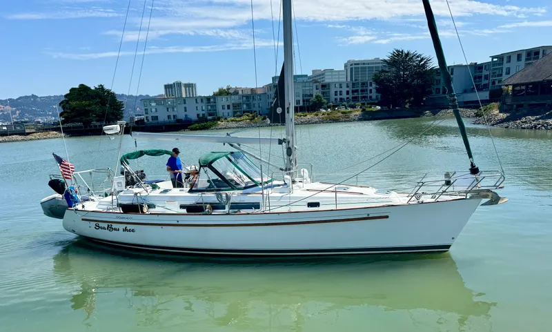 The Image of Beneteau Oceanis 40 CC sailboat from 1996 on calm water near urban buildings. - 0