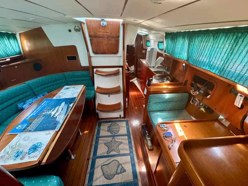 Slide: The Image of Interior of 1996 Beneteau Oceanis 40 CC sailboat with wood finish and green upholstery. - 10