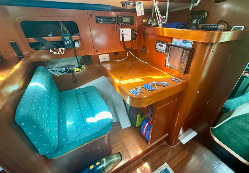 Slide: The Image of Navigation station in 1996 Beneteau Oceanis 40 CC sailboat with wooden desk and blue chair. - 5