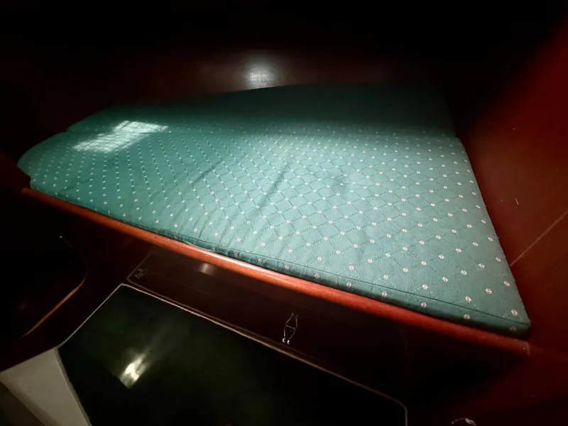 Slide: The Image of Beneteau Oceanis 40 CC 1996 cabin with green cushioned berth. - 6