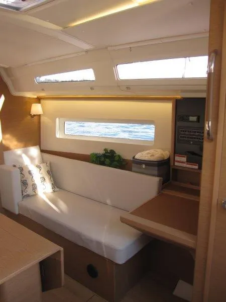 Slide: The Image of Interior of 2024 Jeanneau 380 sailboat with modern seating and natural light. - 13