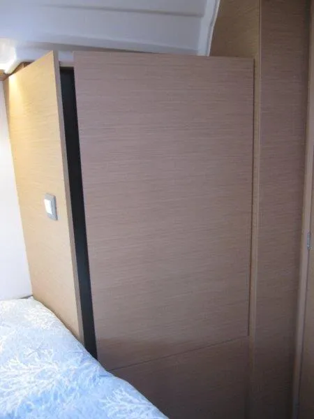 Slide: The Image of Interior cabin of 2024 Jeanneau 380 sailboat with wooden paneling. - 25