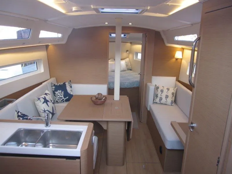 Slide: The Image of Modern interior of 2024 Jeanneau 380 sailboat with cozy seating and dining area. - 3
