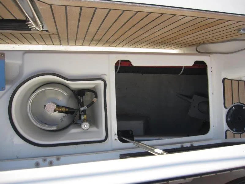 Slide: The Image of Jeanneau 380 2024 model boat storage compartment with gas cylinder. - 42