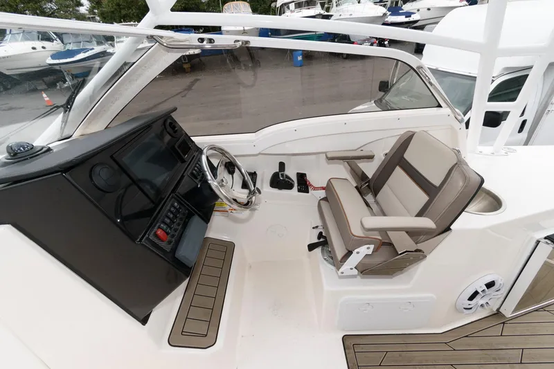 Slide: The Image of 2021 Cutwater C-24 DC boat cockpit with steering wheel and seating. - 12
