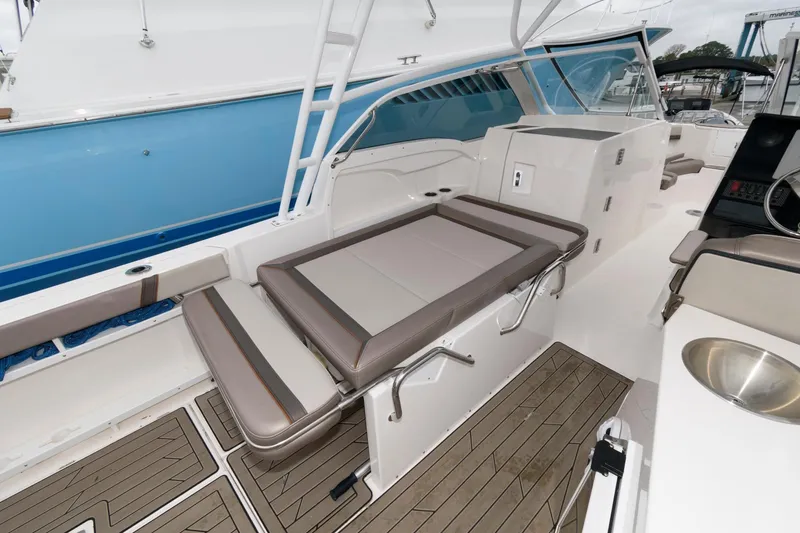 Slide: The Image of 2021 Cutwater C-24 DC boat interior with seating and teak flooring. - 16
