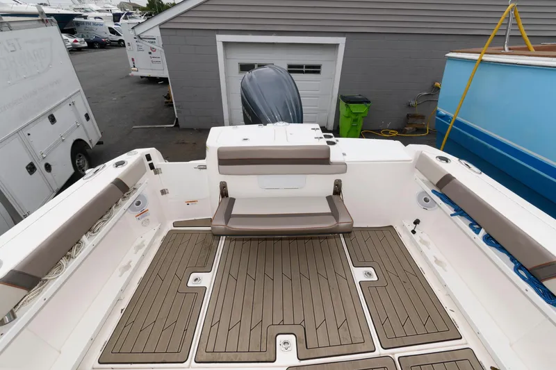 Slide: The Image of 2021 Cutwater C-24 DC boat interior with cushioned seating and teak-style flooring. - 17