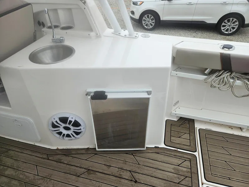 Slide: The Image of 2021 Cutwater C-24 DC boat interior with sink, storage, and speaker. - 19
