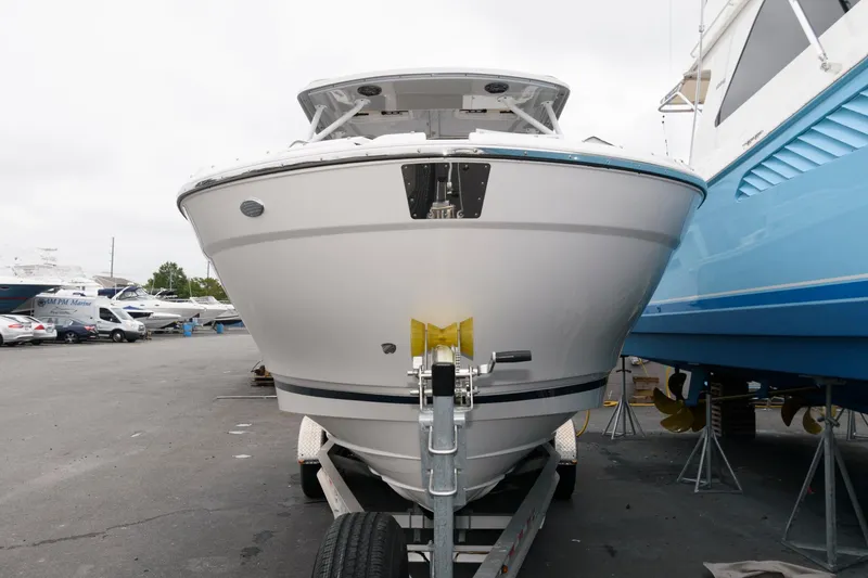 Slide: The Image of 2021 Cutwater C-24 DC boat on trailer in marina setting. - 2