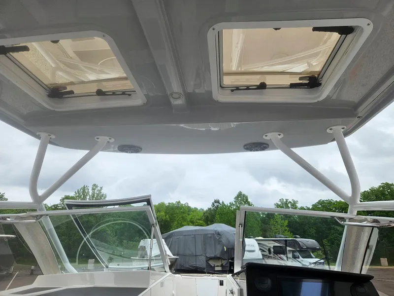 Slide: The Image of 2021 Cutwater C-24 DC boat interior with open hatches and windshield. - 20